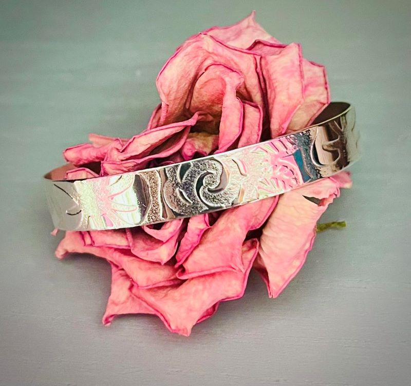 Wide silver cuff with floral pattern texture wrapped a round a dried rose | Silverlicious Artisan Jewellery