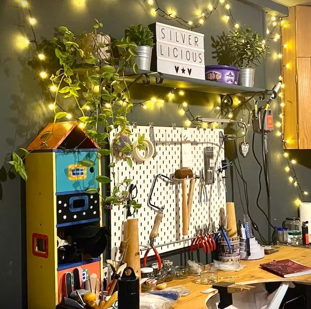 Silverlicious Artisan Jewellery Workshop showing a workbench and jewellers tools on a pegboard on the wall