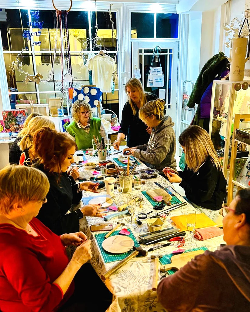 Group of people making jewellery