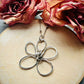 Whimsical Bloom Silver Flower Pendant on a wooden background | Silverlicious Artisan Jewellery