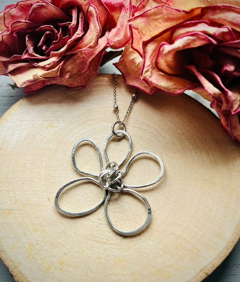 Whimsical Bloom Silver Flower Pendant on a wooden background | Silverlicious Artisan Jewellery